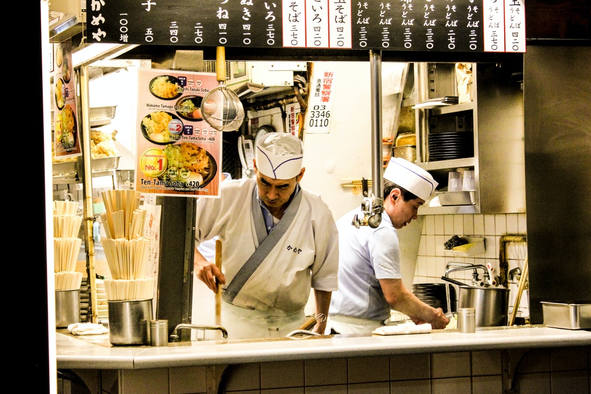 Men cooking ramen at a store